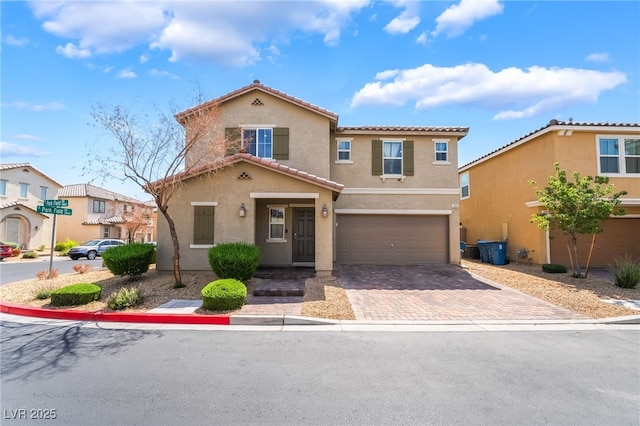3855 Park Field Dr, Las Vegas, NV 89120 - view of front of house featuring stucco siding, an attached garage, a tiled roof, and driveway