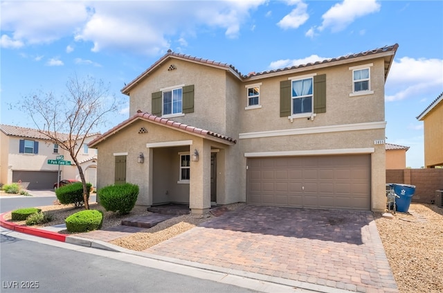 3855 Park Field Dr, Las Vegas, NV 89120 - view of front of house with stucco siding, a tile roof, a garage, and decorative driveway