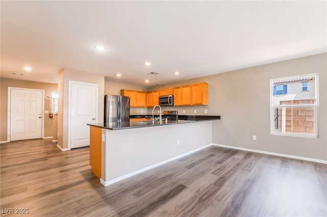 3855 Park Field Dr, Las Vegas, NV 89120 - kitchen with appliances with stainless steel finishes, baseboards, light wood-type flooring, dark countertops, and recessed lighting
