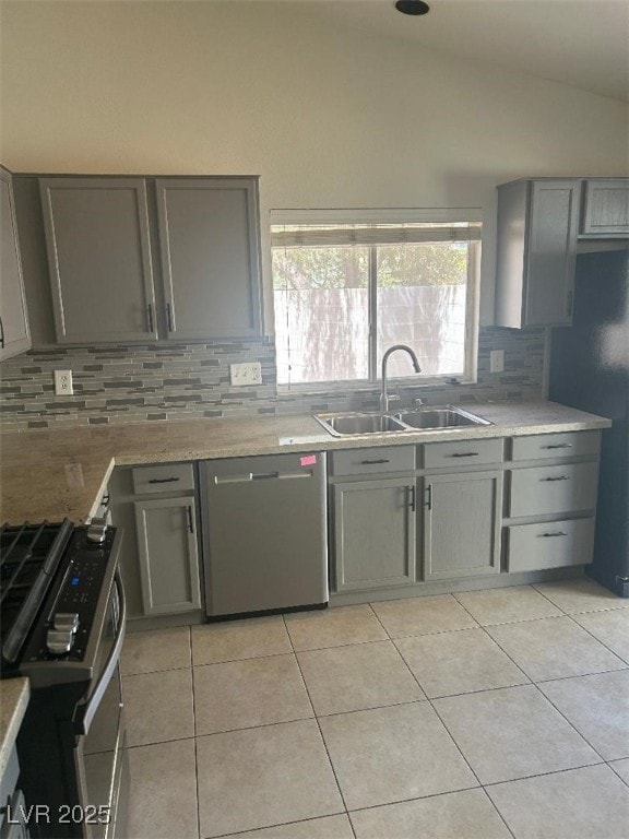 5544 Cloudy Glen St, North Las Vegas, NV 89031 - kitchen featuring gray cabinets, a sink, appliances with stainless steel finishes, lofted ceiling, and backsplash