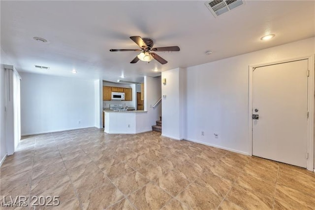 9979 Keephills St, Las Vegas, NV 89183 - unfurnished living room featuring ceiling fan, stairway, baseboards, and recessed lighting