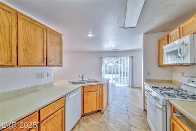 9979 Keephills St, Las Vegas, NV 89183 - kitchen with white appliances, a sink, light countertops, a peninsula, and a textured ceiling