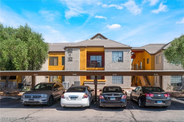 2700 N Rainbow Blvd Unit 1080, Las Vegas, NV 89108 - view of property with covered parking, a tile roof, and stucco siding