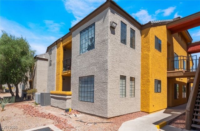 2700 N Rainbow Blvd Unit 1080, Las Vegas, NV 89108 - view of side of home with stucco siding, a balcony, and central AC unit