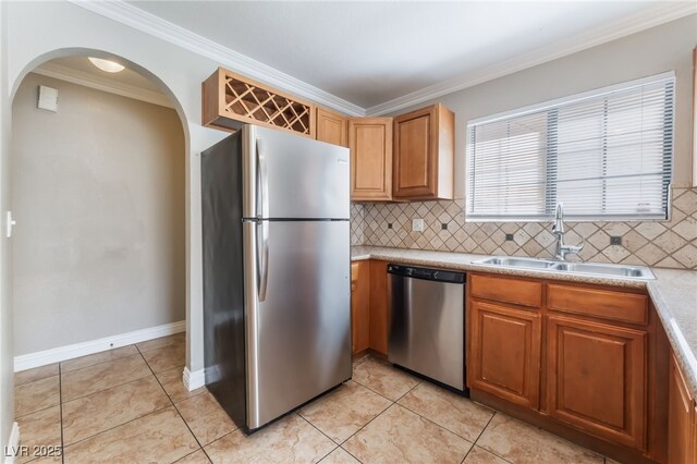 2700 N Rainbow Blvd Unit 1080, Las Vegas, NV 89108 - kitchen featuring stainless steel appliances, a sink, arched walkways, crown molding, and decorative backsplash