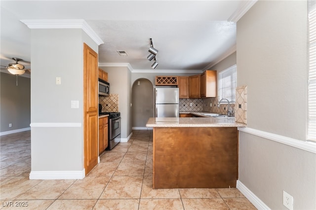 2700 N Rainbow Blvd Unit 1080, Las Vegas, NV 89108 - kitchen featuring stainless steel appliances, a sink, ceiling fan, decorative backsplash, and crown molding