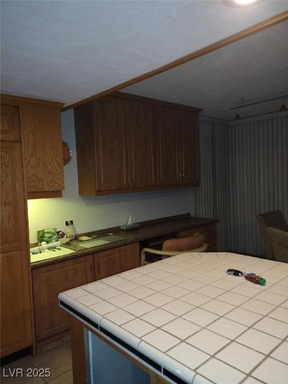 3111 Bel Air Dr Unit 6E, Las Vegas, NV 89109 - kitchen featuring tile counters and light tile patterned flooring