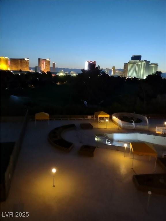 3111 Bel Air Dr Unit 6E, Las Vegas, NV 89109 - view of patio / terrace featuring a pool and a city view