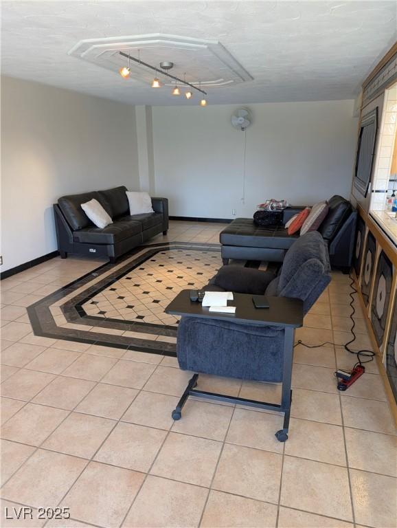 3111 Bel Air Dr Unit 6E, Las Vegas, NV 89109 - living room featuring track lighting, light tile patterned flooring, and attic access