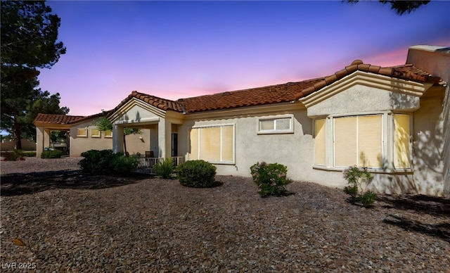 mediterranean / spanish-style house with a tiled roof and stucco siding