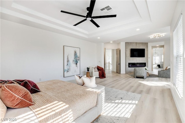5737 Heather Breeze Ct, Las Vegas, NV 89141 - bedroom featuring a raised ceiling, light wood-style flooring, recessed lighting, and ceiling fan