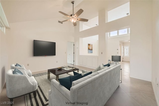 2520 Palmridge Dr, Las Vegas, NV 89134 - tiled living room featuring a ceiling fan, a high ceiling, and baseboards
