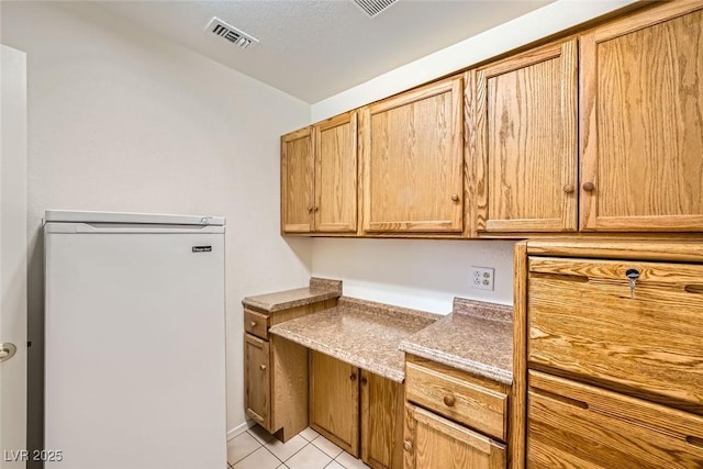 2520 Palmridge Dr, Las Vegas, NV 89134 - kitchen with fridge and light tile patterned floors
