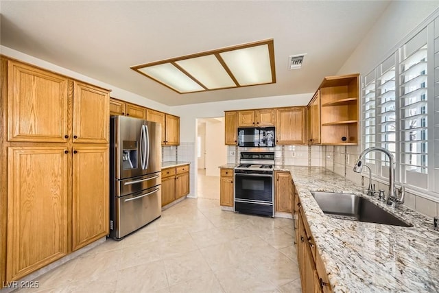 2520 Palmridge Dr, Las Vegas, NV 89134 - kitchen with stainless steel refrigerator with ice dispenser, black microwave, gas range, a sink, and open shelves