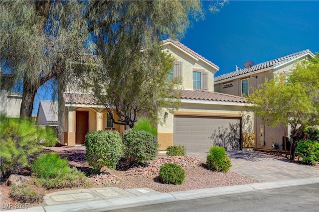 view of front of property with a tiled roof, stucco siding, a garage, and driveway