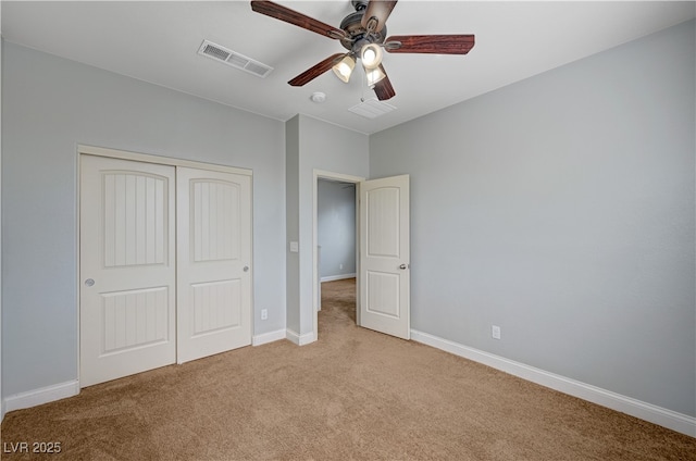 unfurnished bedroom featuring carpet flooring, a closet, baseboards, and a ceiling fan