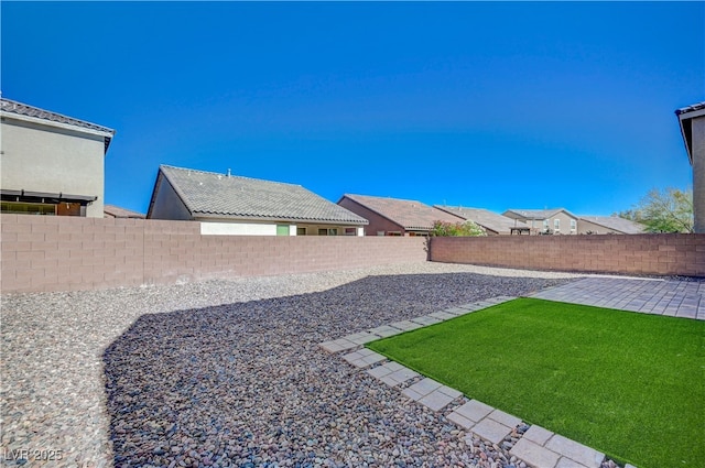 fenced backyard featuring a patio area