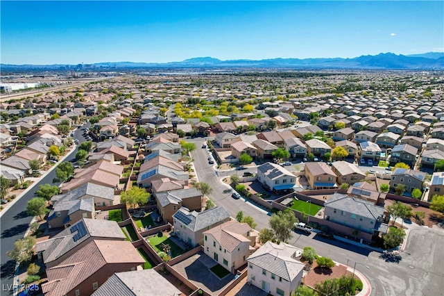 aerial view of residential area featuring a mountainous background