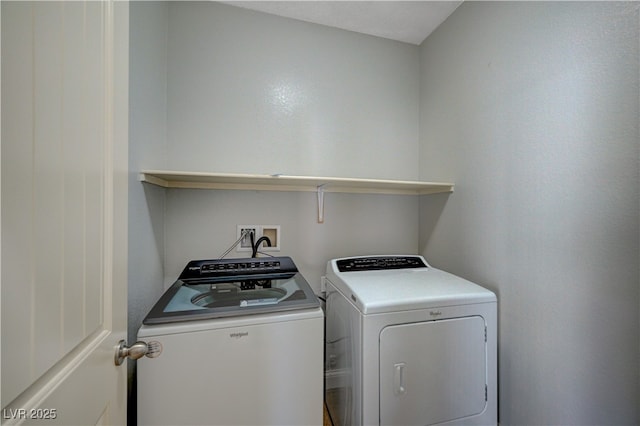 clothes washing area with washing machine and clothes dryer