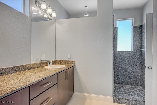 full bath featuring vanity and a tile shower