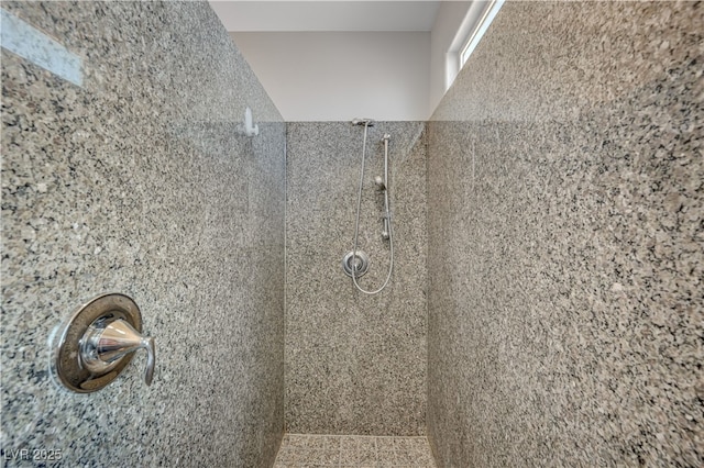 bathroom with tiled shower