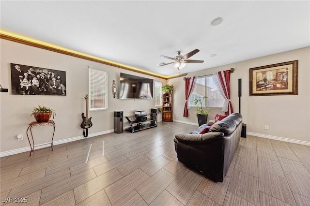 living room with ceiling fan, wood tiled floors, and baseboards