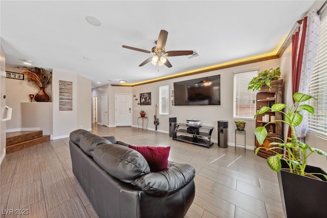 living room featuring ceiling fan and baseboards