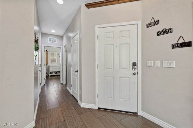 corridor with baseboards and recessed lighting