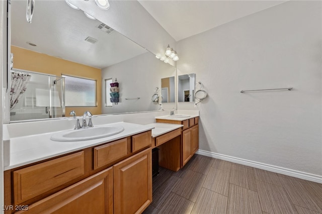 bathroom with an enclosed shower, vanity, and baseboards