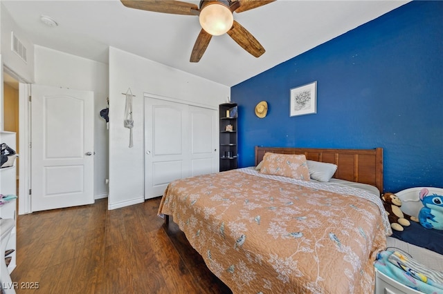 bedroom with wood finished floors, a closet, and a ceiling fan
