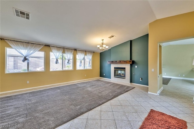 unfurnished living room with vaulted ceiling, a chandelier, light tile patterned floors, baseboards, and a fireplace
