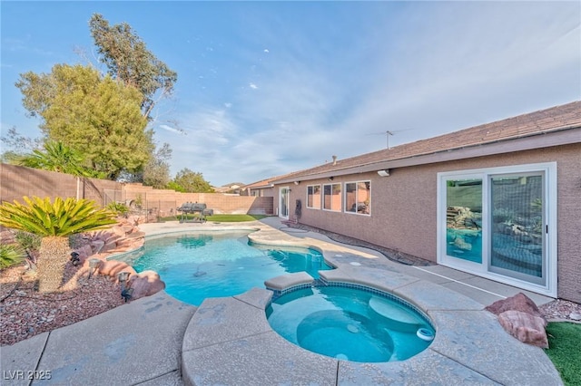 view of swimming pool featuring a patio area, a fenced backyard, and a pool with connected hot tub