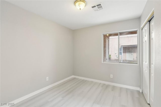 unfurnished bedroom with wood finished floors, a closet, and baseboards