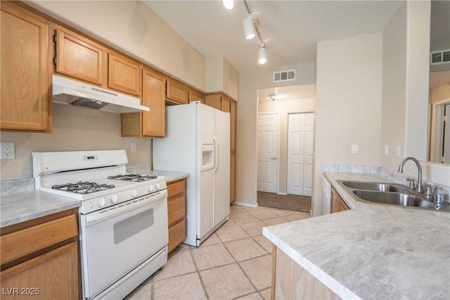 1050 E Cactus Ave Unit 1128, Las Vegas, NV 89183 - kitchen featuring white appliances, a sink, under cabinet range hood, light tile patterned floors, and light countertops