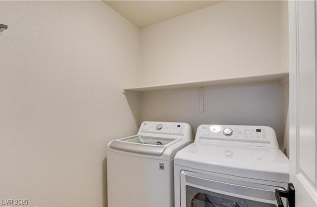 clothes washing area featuring washing machine and clothes dryer
