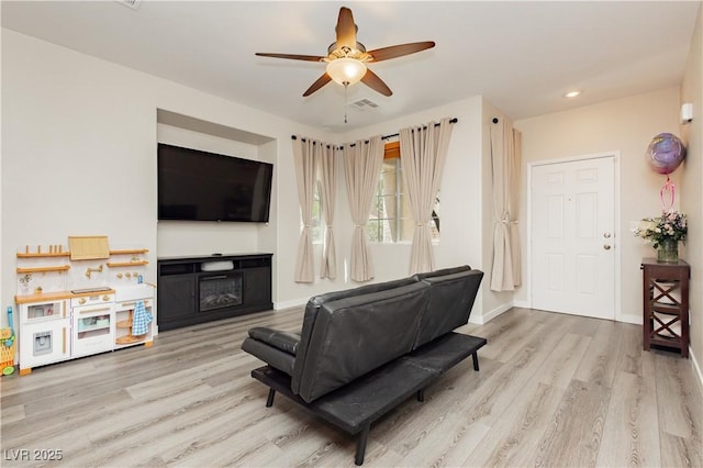 8717 Early Horizon Dr, Las Vegas, NV 89178 - living area featuring light wood-style floors, a ceiling fan, recessed lighting, baseboards, and a fireplace