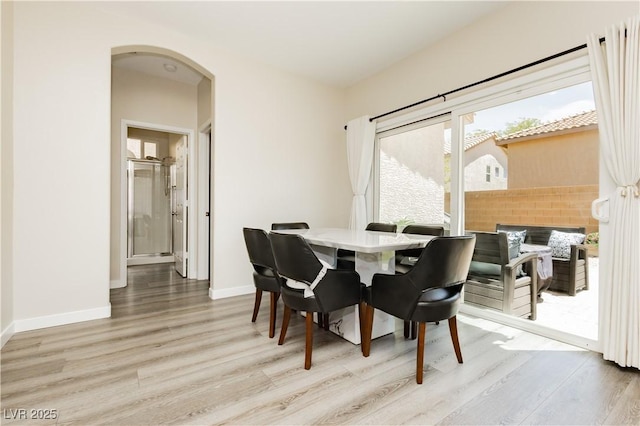 8717 Early Horizon Dr, Las Vegas, NV 89178 - dining space with light wood-type flooring, arched walkways, and baseboards