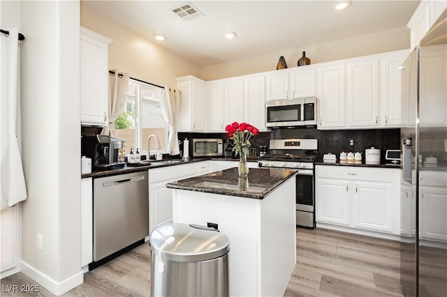 8717 Early Horizon Dr, Las Vegas, NV 89178 - kitchen featuring stainless steel appliances, a sink, white cabinets, a kitchen island, and recessed lighting