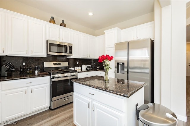 8717 Early Horizon Dr, Las Vegas, NV 89178 - kitchen featuring appliances with stainless steel finishes, white cabinetry, light wood finished floors, and recessed lighting