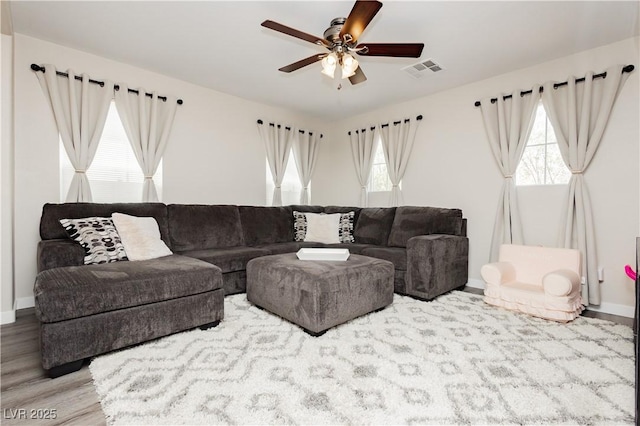 8717 Early Horizon Dr, Las Vegas, NV 89178 - living area with wood finished floors, plenty of natural light, ceiling fan, and baseboards
