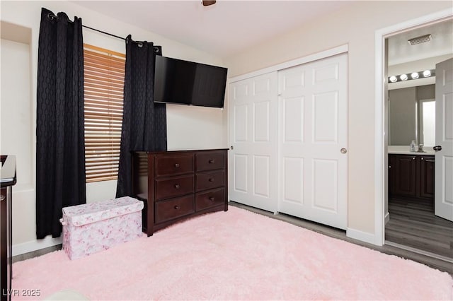 8717 Early Horizon Dr, Las Vegas, NV 89178 - bedroom with a closet, wood finished floors, and baseboards