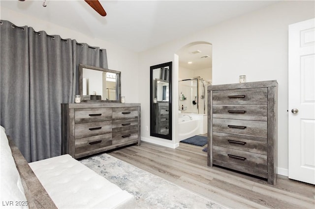 8717 Early Horizon Dr, Las Vegas, NV 89178 - bedroom with arched walkways, wood finished floors, ensuite bath, and baseboards