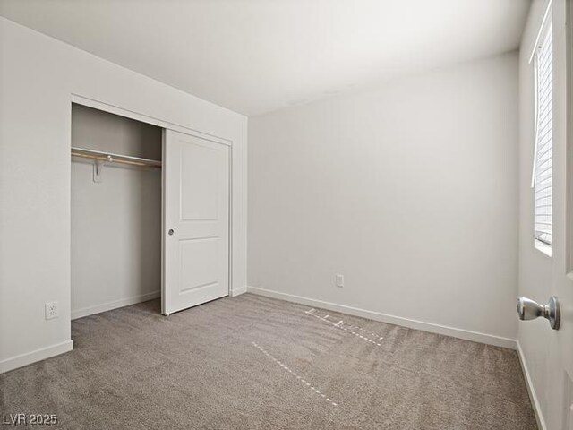 4830 Double Down Dr Unit 102, Las Vegas, NV 89122 - unfurnished bedroom with carpet, baseboards, and a closet