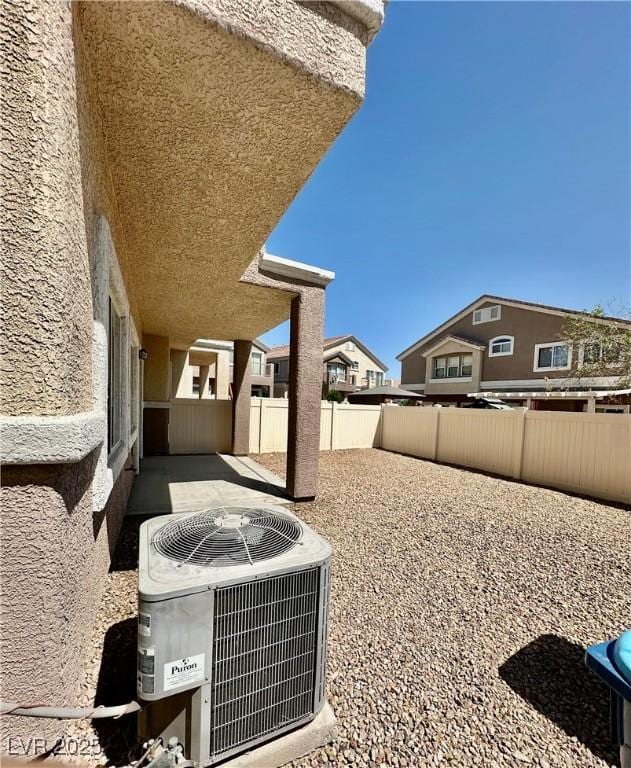 4830 Double Down Dr Unit 102, Las Vegas, NV 89122 - view of patio / terrace featuring central AC and a fenced backyard