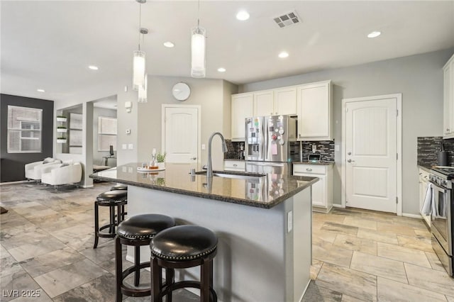 334 E Neal Ave, Las Vegas, NV 89183 - kitchen featuring a sink, appliances with stainless steel finishes, tasteful backsplash, white cabinetry, and recessed lighting