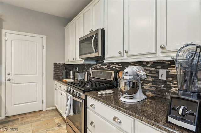334 E Neal Ave, Las Vegas, NV 89183 - kitchen with stainless steel appliances, tasteful backsplash, dark stone counters, and white cabinets