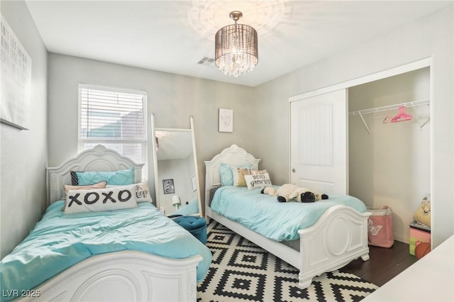 334 E Neal Ave, Las Vegas, NV 89183 - bedroom featuring a closet, a chandelier, and dark wood-style floors