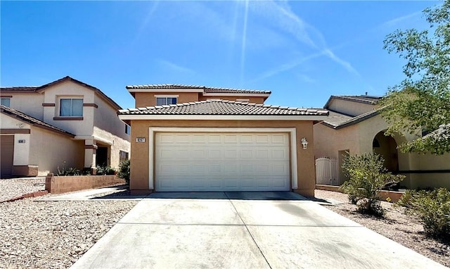 view of front of house with concrete driveway, an attached garage, stucco siding, and a tiled roof