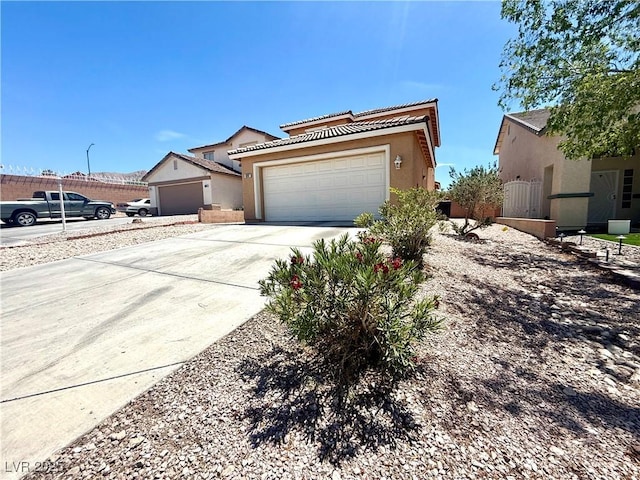traditional home with a tile roof, stucco siding, and concrete driveway