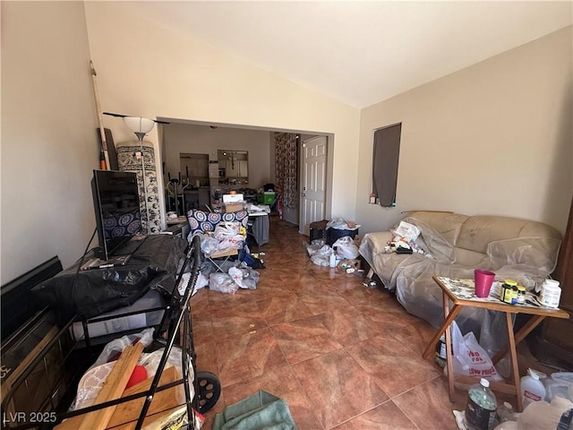 living area with lofted ceiling and tile patterned floors